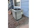 Exterior shot showcasing a gray air conditioning unit on a gravel-covered area at 5365 Shake Ct # 103, Las Vegas, NV 89122