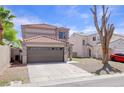 Charming two-story home with tile roof, desert landscaping, and attached two car garage at 5853 Calobar Ln, Las Vegas, NV 89110