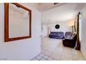 Bright living room with tile flooring, neutral paint, and view to adjacent rooms at 5853 Calobar Ln, Las Vegas, NV 89110