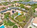 This stunning aerial view showcases a private backyard, a sparkling pool, mature landscaping and a playground at 5889 Taylor Valley Ave, Las Vegas, NV 89131