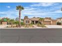 Charming single-story home with a three-car garage, desert landscaping, and palm trees at 5889 Taylor Valley Ave, Las Vegas, NV 89131