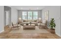 Bright living room features neutral décor, a cozy seating arrangement, and plenty of natural light at 5889 Taylor Valley Ave, Las Vegas, NV 89131