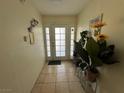 Inviting foyer with tile flooring, decorative plants, and a frosted glass front door at 6117 Cromwell Cir, Las Vegas, NV 89107