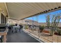Spacious patio with a table and chairs, featuring a grill, views, and a protected space at 621 Mount Elbert Way, Boulder City, NV 89005
