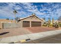 A house with a two-car garage, side yard access, and xeriscaping at 6308 Canyon Ridge Dr, Las Vegas, NV 89108