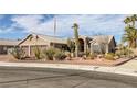 Attractive single-story house featuring desert landscaping, a brick border, and a warm, inviting facade at 6308 Canyon Ridge Dr, Las Vegas, NV 89108