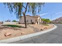 Single Gathering home with desert landscaping, and a mountain view in the background at 6638 Dazzling Heights Ln, Las Vegas, NV 89110