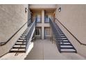 Dual stairwells provide access to the upper-level apartments in this condo complex at 6680 Caporetto Ln # 103, North Las Vegas, NV 89084