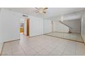 An open-plan living room featuring tile flooring and a mirrored wall at 7084 Burcot Ave # D27, Las Vegas, NV 89156