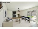Living room with modern decor, statement fireplace, and sliding glass doors to the backyard at 744 Willow Ave, Henderson, NV 89002
