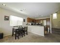 Open concept kitchen area with stainless steel appliances and a cozy dining area at 7653 Fabled Filigree St, Las Vegas, NV 89149