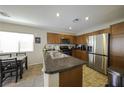Stylish kitchen featuring stainless steel appliances, tile floors, and ample countertop space at 7653 Fabled Filigree St, Las Vegas, NV 89149