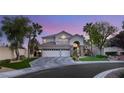 Beautiful two-story home with a three-car garage and well-manicured front yard with mature palm trees at 8801 Rozetta Ct, Las Vegas, NV 89134