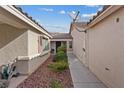 Side yard features rock landscaping and a paved walkway, creating a clean and modern aesthetic at 9284 Lopseed Ct, Las Vegas, NV 89149