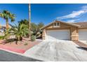 Inviting single-story home featuring a two-car garage and desert landscaping at 9436 Mount Cash Ave # 101, Las Vegas, NV 89129