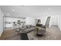 Bright and open-concept living room with modern finishes and wood flooring throughout the main level at 100 Via Franello, Henderson, NV 89011
