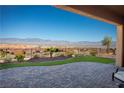 Backyard patio with brick pavers and desert landscaping offering stunning mountain views at 1130 Calico Rdg, Mesquite, NV 89034