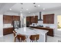 Modern kitchen with a large island, stainless steel appliances, and sleek countertops at 1130 Calico Rdg, Mesquite, NV 89034