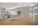Spacious kitchen with white cabinets, stainless steel appliances, and an island, all bathed in natural light at 4010 Herblinda Ln, North Las Vegas, NV 89032