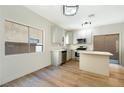 Bright kitchen featuring white cabinets, stainless steel appliances, and a center island with a breakfast bar at 5774 Typecast Rd, Las Vegas, NV 89142