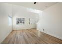 Bright, open living room with wood-look floors and high ceilings at 5774 Typecast Rd, Las Vegas, NV 89142