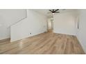 Spacious living room featuring wood-look floors and modern lighting at 5774 Typecast Rd, Las Vegas, NV 89142