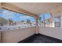 Private covered balcony with views of the surrounding community, perfect for enjoying the outdoors at 921 Sulphur Springs Ln # 201, Las Vegas, NV 89128