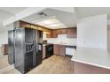 Functional kitchen with ample counter space, sleek black appliances and wood-look floors at 921 Sulphur Springs Ln # 201, Las Vegas, NV 89128