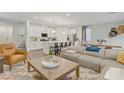 Open floor plan with kitchen island, living area, and dining table at 2742 Zazzera Ct, Henderson, NV 89044