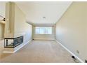 Bright living room featuring a modern fireplace and large window with outdoor views at 3523 Calf Roper Ct, North Las Vegas, NV 89032