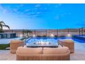 Luxury pool area with stunning desert and lake views, an outdoor kitchen, and modern fire pit lounge at 36 Thorn Creek St, Henderson, NV 89011