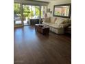 Bright living room with hardwood floors, comfortable sofa and seamless access to the outdoor patio at 682 Oakmont Ave # 1507, Las Vegas, NV 89109