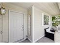 Close-up of front door and porch area, creating a warm and welcoming entry at 7729 Natures Song St, Las Vegas, NV 89131