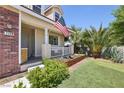 Charming front porch with a well-maintained yard and desert landscaping at 7729 Natures Song St, Las Vegas, NV 89131