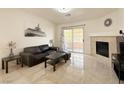 Stylish living room features tile flooring, a cozy fireplace, and sliding glass doors to a private balcony at 8452 Boseck Dr # 225, Las Vegas, NV 89145