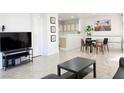 Bright living space with tile floors, open layout to kitchen and dining area, and a modern entertainment center at 8452 Boseck Dr # 225, Las Vegas, NV 89145