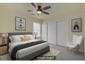 Cozy bedroom with a ceiling fan, a large window and neutral color scheme at 9932 Keephills St, Las Vegas, NV 89183