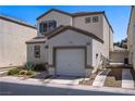 Two-story home with a garage and a well-maintained front yard at 9932 Keephills St, Las Vegas, NV 89183