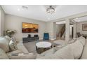 Comfortable living room with a sectional sofa, stylish decor, and plenty of space for entertaining at 10189 Magnolia Creek St, Las Vegas, NV 89141