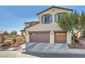 Inviting two-story home boasts a two-car garage, desert landscaping, and charming architectural details at 10611 Auburn Springs Ave, Las Vegas, NV 89166