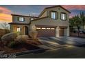 Attractive two-story home with terracotta roof at dusk and attached two-car garage at 10611 Auburn Springs Ave, Las Vegas, NV 89166