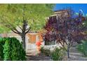 Well-maintained home featuring a two-car garage, complemented by lush trees and decorative holiday accents at 11117 Romola St, Las Vegas, NV 89141