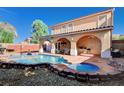 A private pool and spa offer a luxurious outdoor retreat with a covered patio and manicured landscaping at 11117 Romola St, Las Vegas, NV 89141