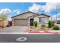 Single-story home featuring a two-car garage, low-maintenance landscaping, and neutral color palette at 1265 Inward Hill St, Henderson, NV 89002