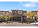 Beautiful two-story home featuring a gray exterior, two-car garage, and landscaped front yard at 127 Medianoche St, Las Vegas, NV 89138