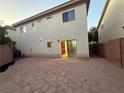 Large backyard with a flagstone patio, access to the house, and privacy from neighboring homes at 141 Gryffin Ave, Las Vegas, NV 89123