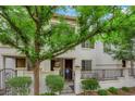 Townhouse exterior showcasing a gated front yard with lush landscaping at 1525 Spiced Wine Ave # 10102, Henderson, NV 89074