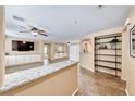 Open-concept living area featuring neutral paint, tile flooring, built-in storage and shelving at 173 Calm Morning Ave, Henderson, NV 89002