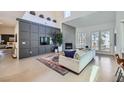 Cozy living room featuring a fireplace, plush sofa, and access to a patio at 176 Tierra Bonita Ct, Henderson, NV 89074
