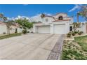 Stylish two-story home with tile roof, an attached two-car garage, and low-maintenance desert landscaping at 227 Drysdale Cir, Henderson, NV 89074